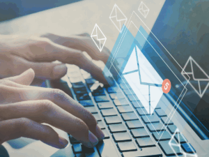 Hands typing on a keyboard. There is a notification of unread emails.